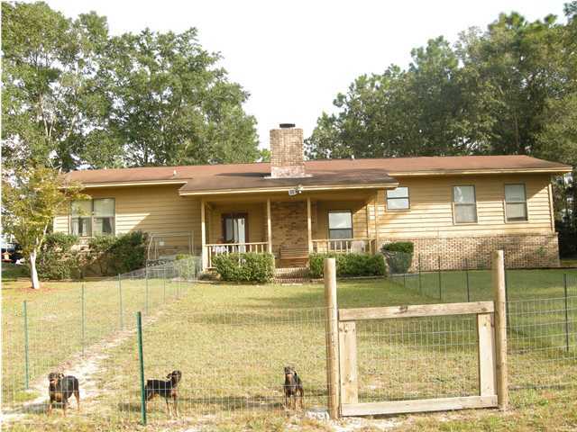 1083 Tallokas Road Crestview, FL 32536 - Photo 23 of 35 a front view of a house with a yard