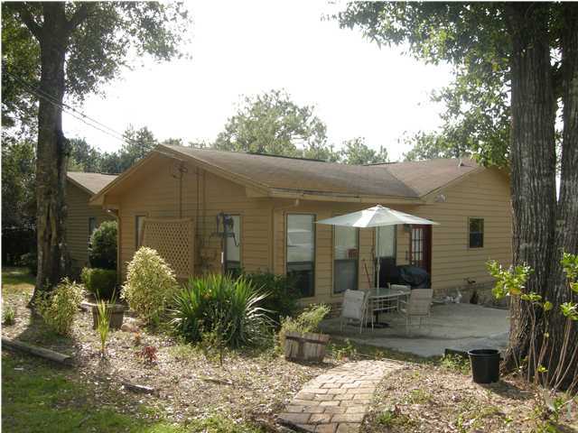 1083 Tallokas Road Crestview, FL 32536 - Photo 30 of 35 a front view of a house with garden