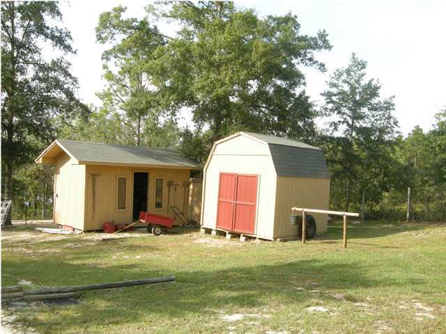 1083 Tallokas Road Crestview, FL 32536 - Photo 31 of 35 a view of a house with a yard and sitting area