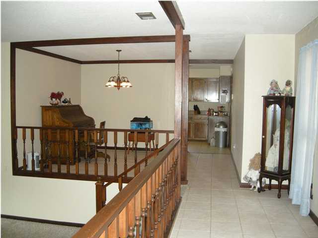 1083 Tallokas Road Crestview, FL 32536 - Photo 9 of 35 a view of a hallway with wooden floor and stairs