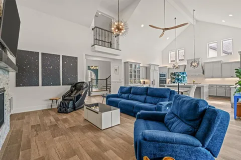 a living room with furniture gym equipment and a flat screen tv