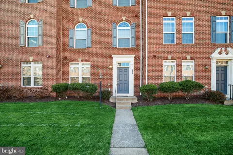 a front view of a brick house with a yard