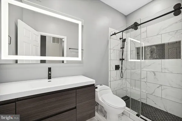 a bathroom with a sink toilet and shower