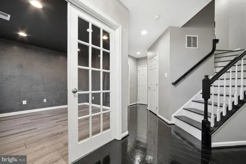 a view of staircase with wooden floor and windows