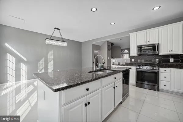 a kitchen with stainless steel appliances granite countertop a sink and cabinets