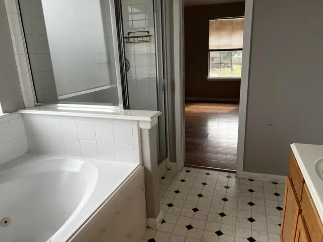 a bathroom with a bathtub and a shower
