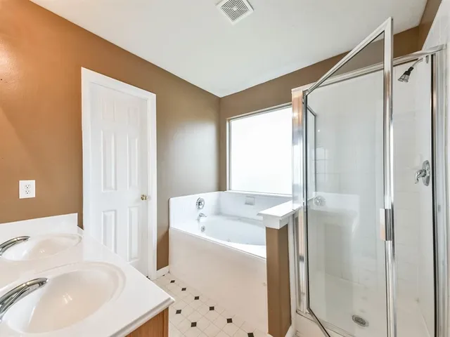 a en suite bathroom with a sink a mirror and a shower