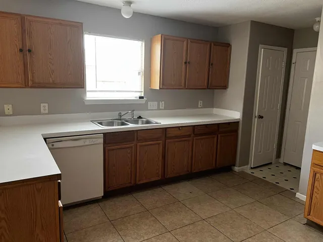 a kitchen with a sink cabinets and window