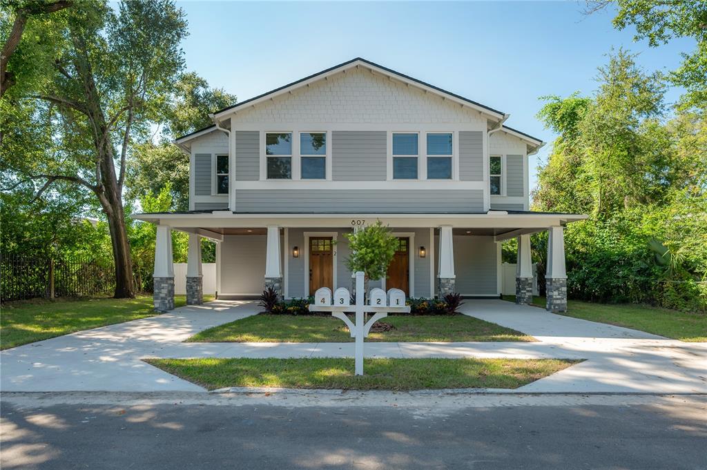 a front view of a house with a yard and porch