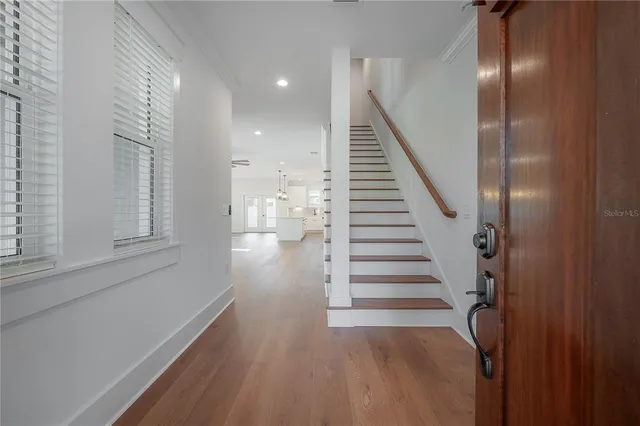 a view of entryway and hall with wooden floor