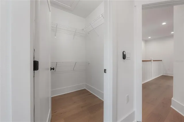 a view of a hallway with wooden floor