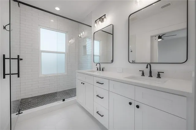 a bathroom with double sink and a mirror