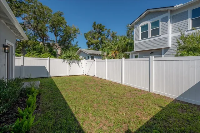 a backyard of a house with plants and trees