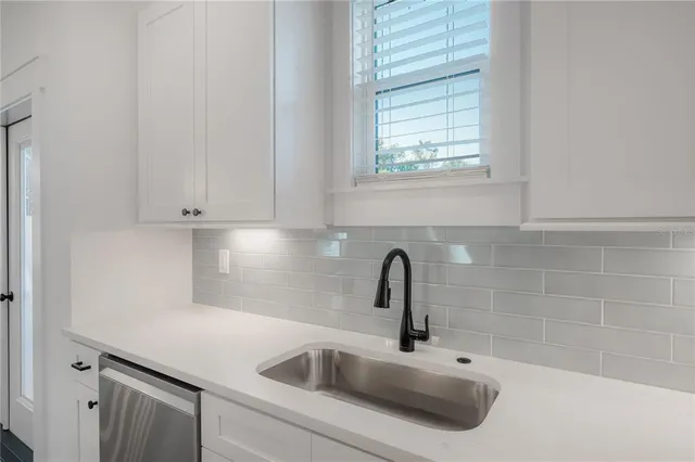 a close view of a sink and dishwasher in a kitchen