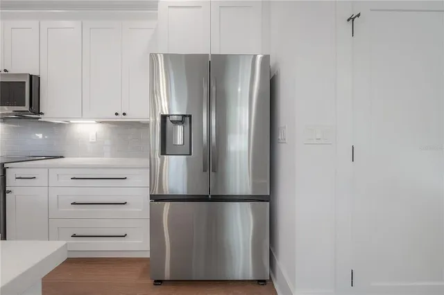 a refrigerator freezer sitting in a kitchen