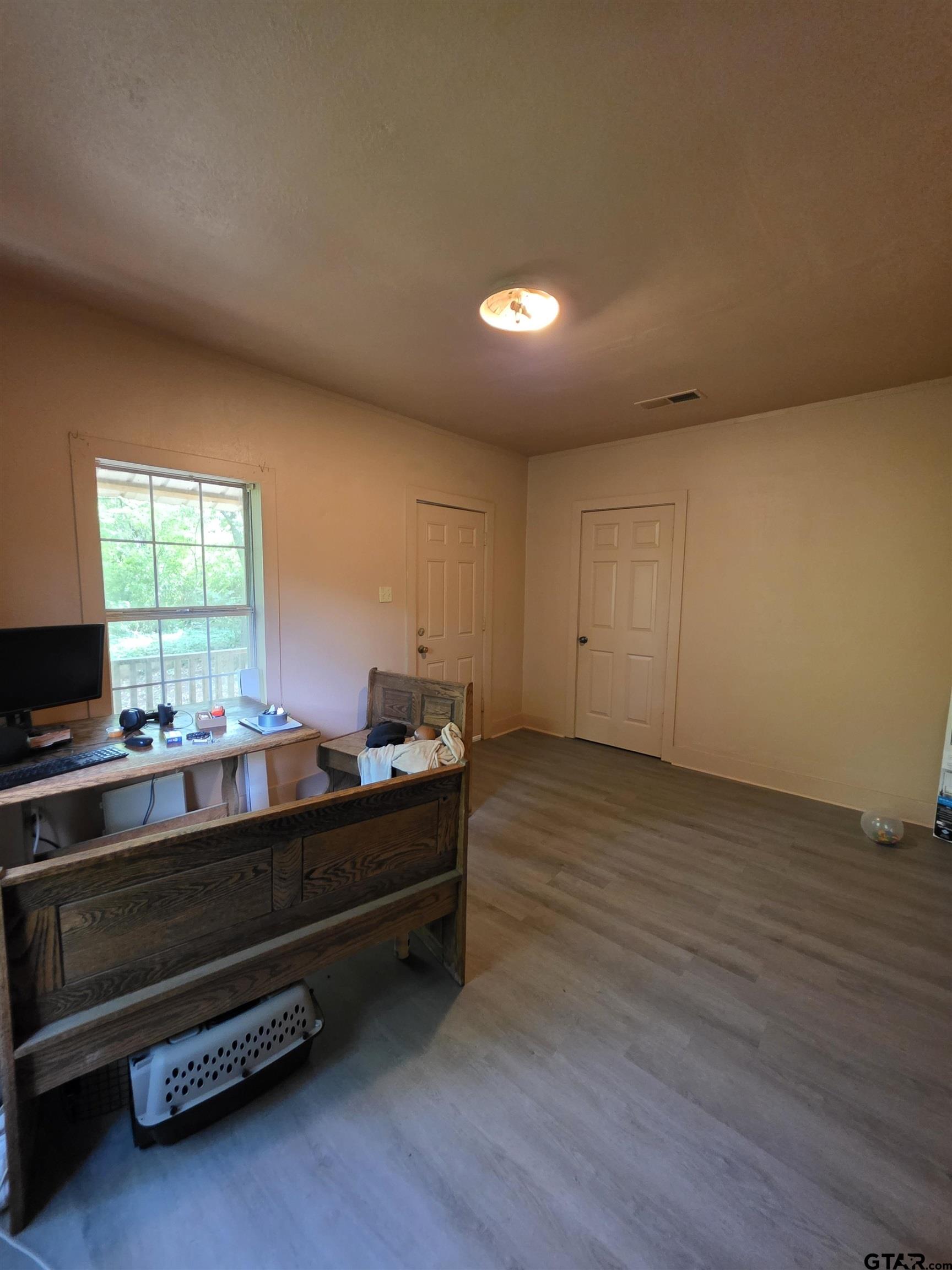 316 North Hospital Street Rusk, TX 75785 - Photo 20 of 21 a room with wooden floor and furniture