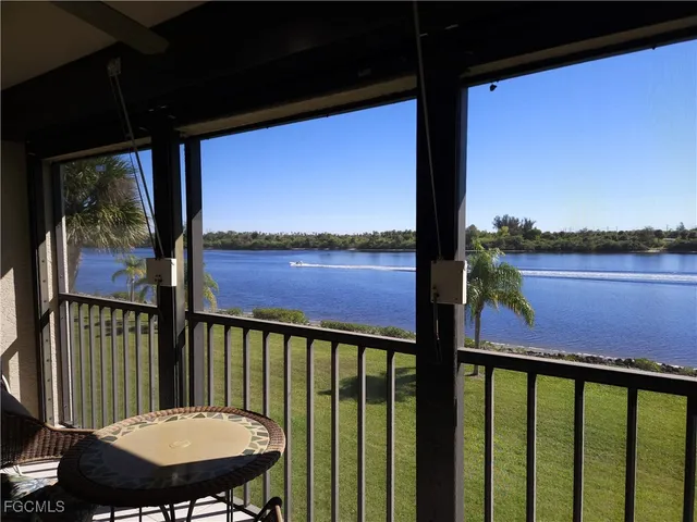 a view of a balcony with lake view and wooden floor
