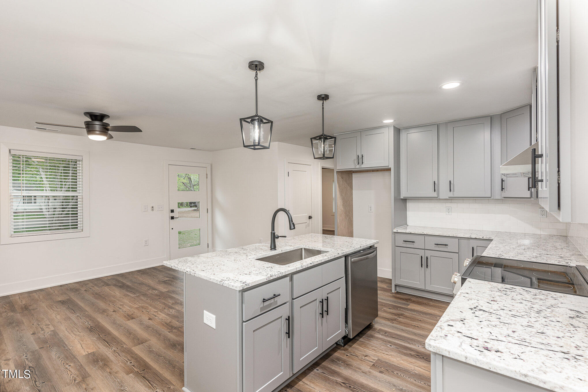 415 Lamont Street Raleigh, NC 27610 - Photo 6 of 13 a kitchen with a sink stove and cabinets