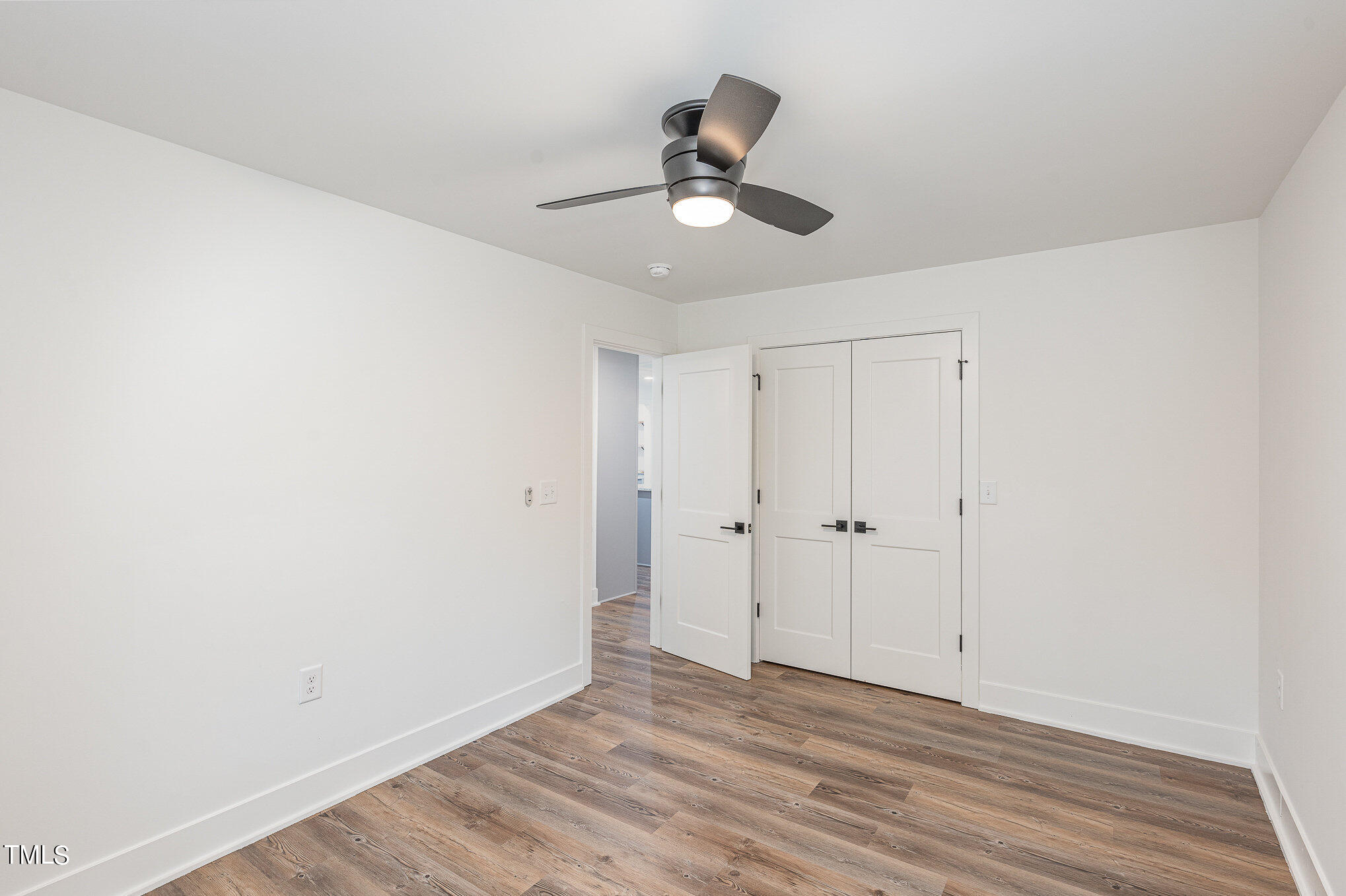 415 Lamont Street Raleigh, NC 27610 - Photo 7 of 13 a view of an empty room and wooden floor