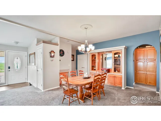 a view of a dining room with furniture and chandelier