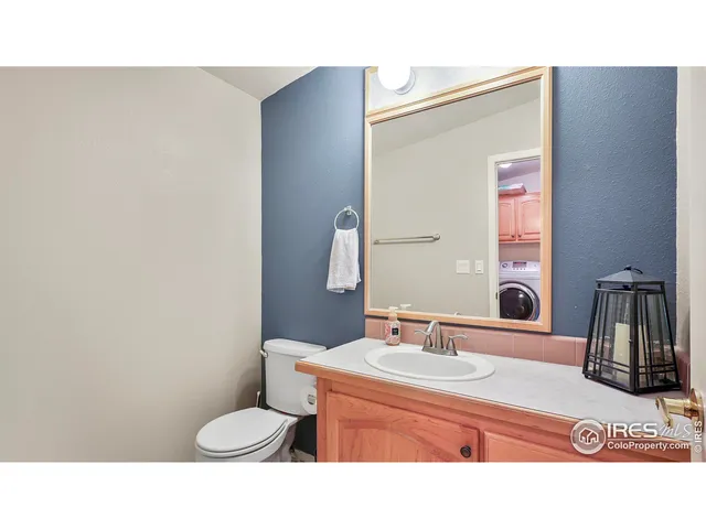 a bathroom with a sink vanity mirror and toilet