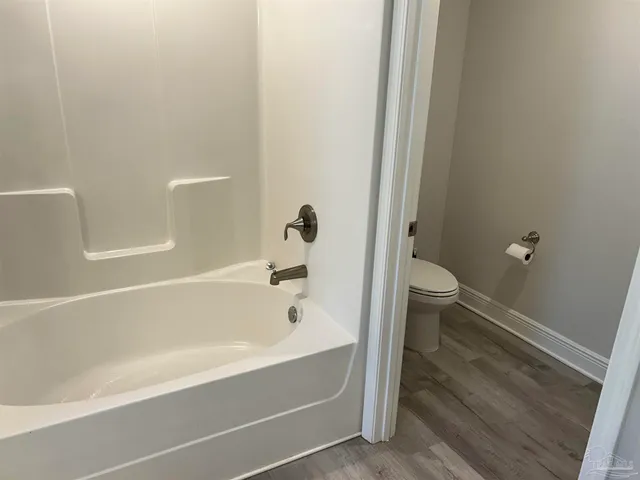 a bathroom with a bathtub and toilet