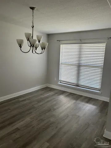 a view of a room with wooden floor and windows