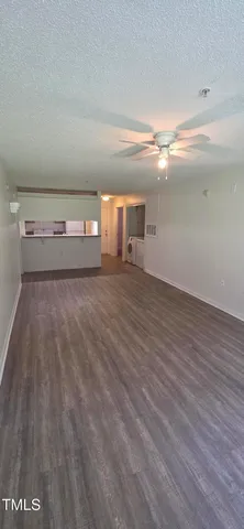 a view of a room with wooden floor