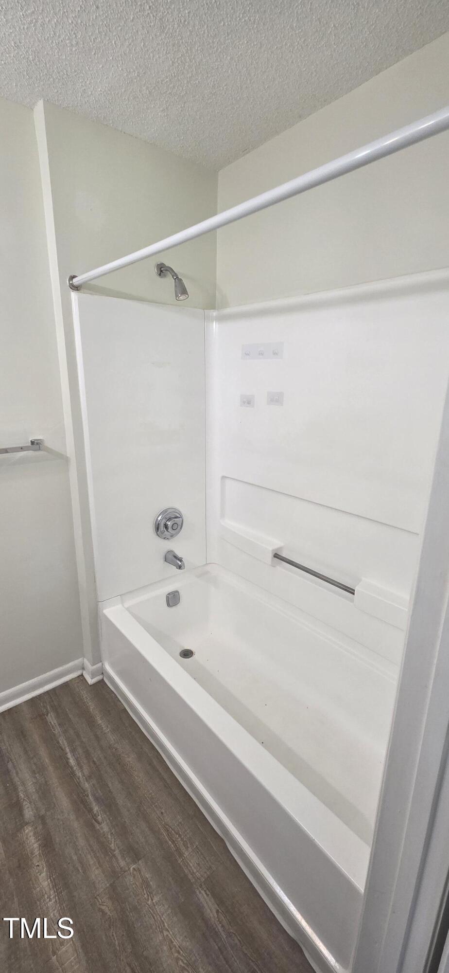 1401 Collegiate Circle, Unit 104 Raleigh, NC 27606 - Photo 23 of 29 a bathroom with a bathtub and a shower