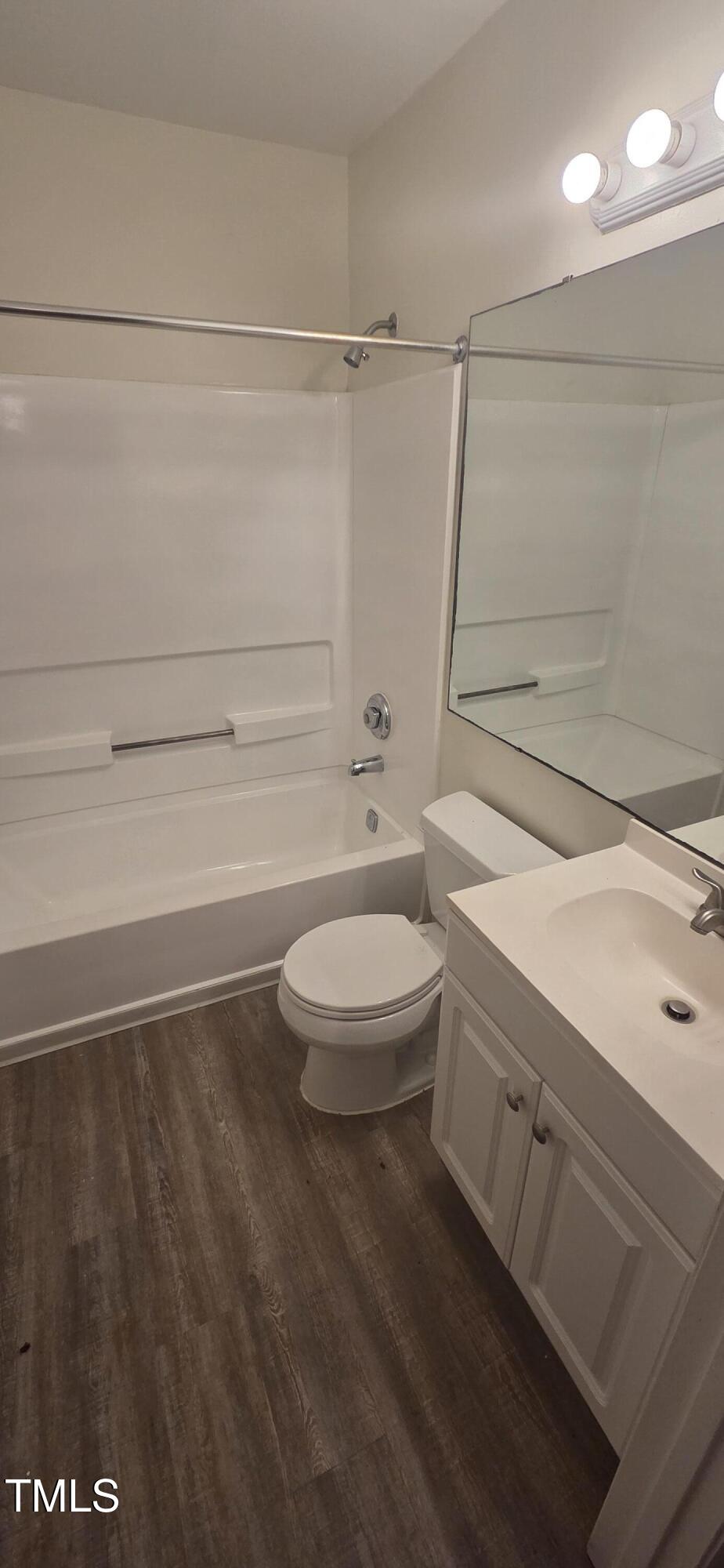 1401 Collegiate Circle, Unit 104 Raleigh, NC 27606 - Photo 27 of 29 a bathroom with a toilet a sink and shower