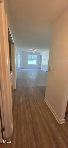 a view of a room with wooden floor and window