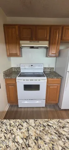 a stove top oven sitting inside of a kitchen