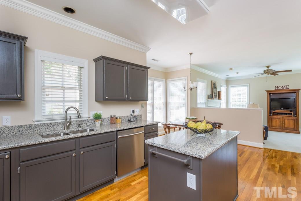 11817 Radner Way Raleigh, NC 27613 - Photo 15 of 15 a kitchen with stainless steel appliances granite countertop a sink a stove counter space and cabinets