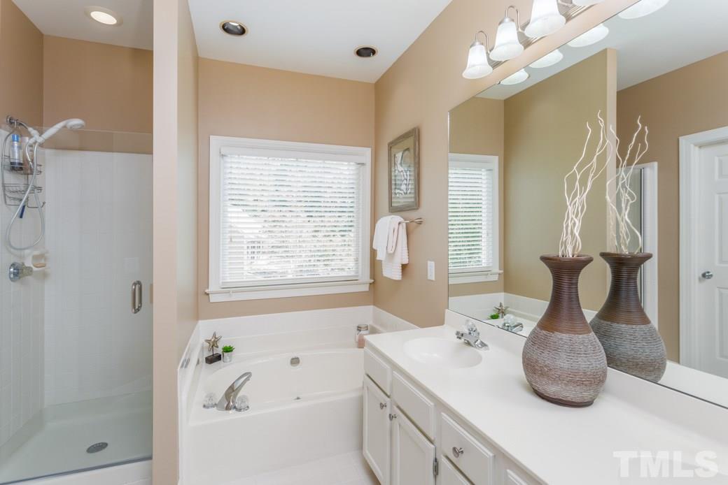 11817 Radner Way Raleigh, NC 27613 - Photo 4 of 15 a bathroom with a tub sink and mirror