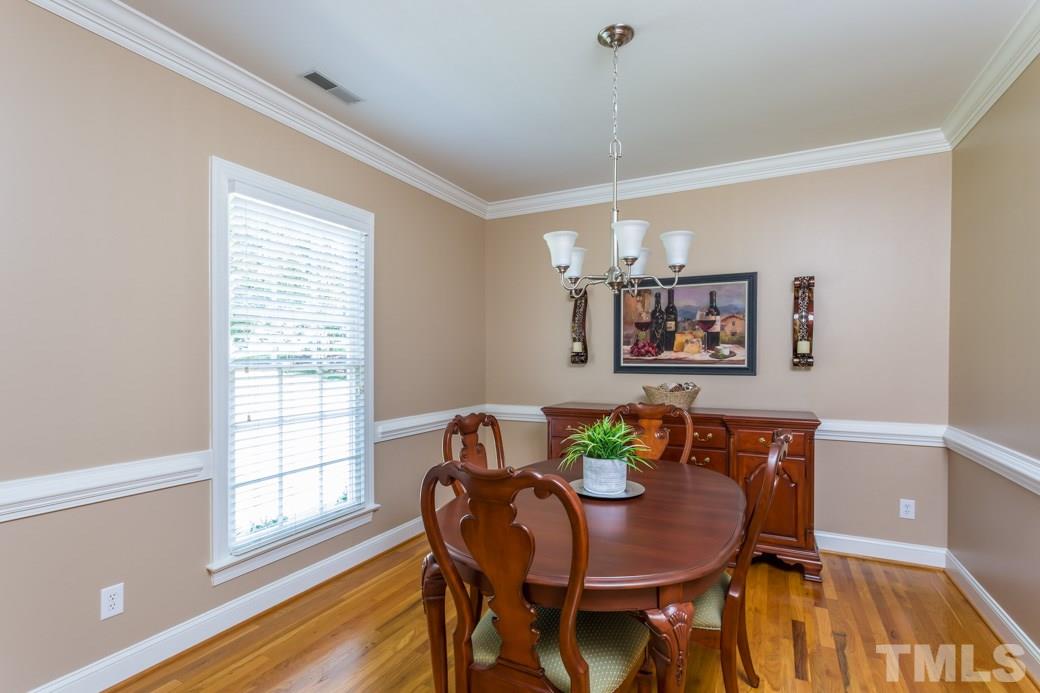 11817 Radner Way Raleigh, NC 27613 - Photo 6 of 15 a view of a dining room with furniture and wooden floor