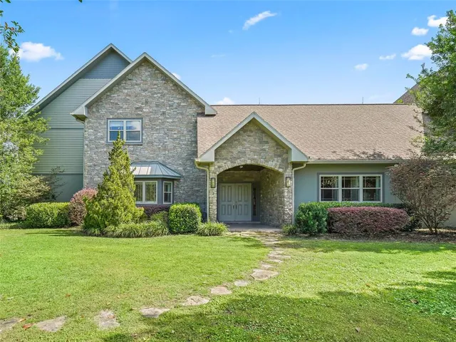 an aerial view of ocean residential house with outdoor space and trees all around