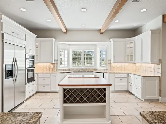 a spacious bedroom with a bed and a window