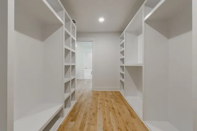 a view of staircase with white walls and railing