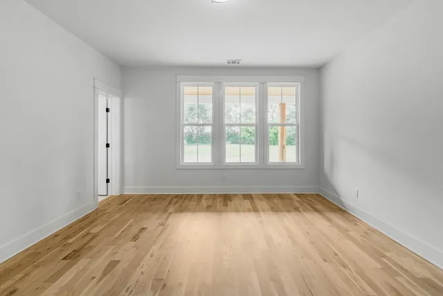 a view of a hallway with windows and stairs