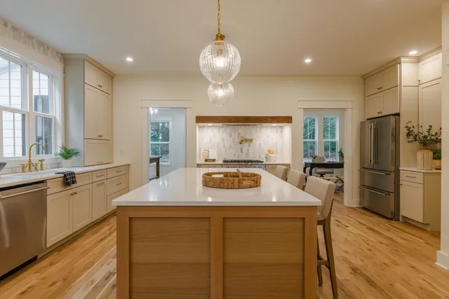 a kitchen with a table chairs sink and cabinets
