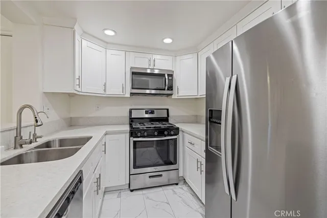 a kitchen with a sink stove and refrigerator