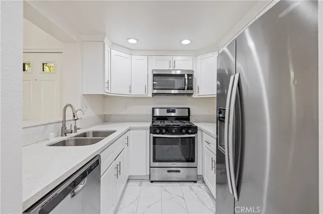 a kitchen with a sink stove and refrigerator