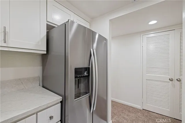 a metallic refrigerator freezer sitting in a kitchen