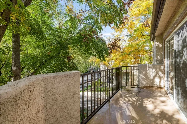 a view of balcony with wooden floor and fence