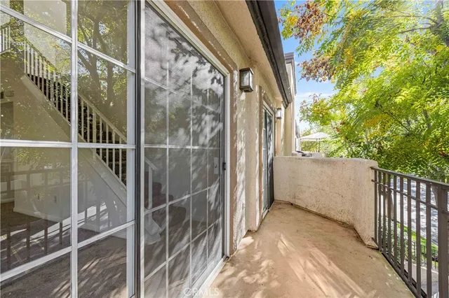 a view of a balcony with tree