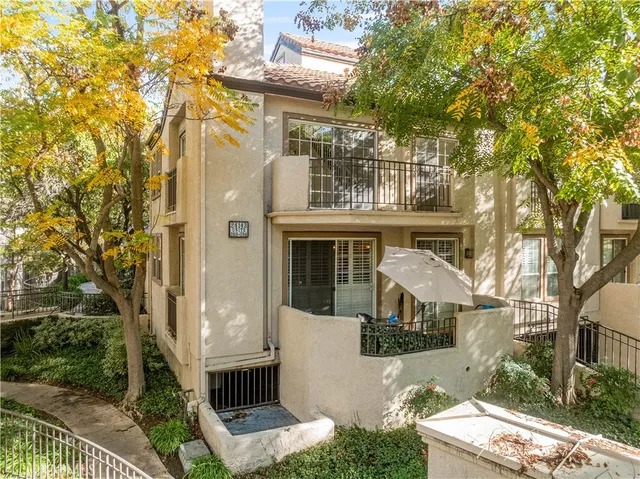a front view of a house with trees