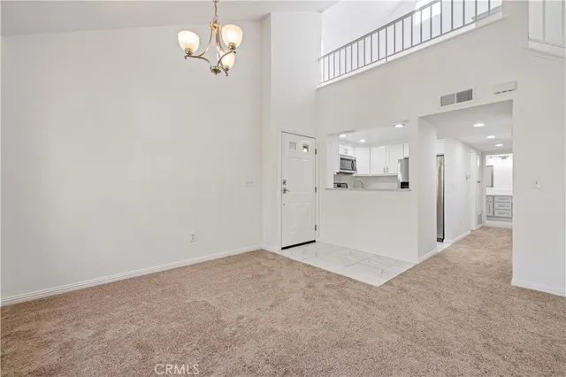 a view of a kitchen with a sink and refrigerator