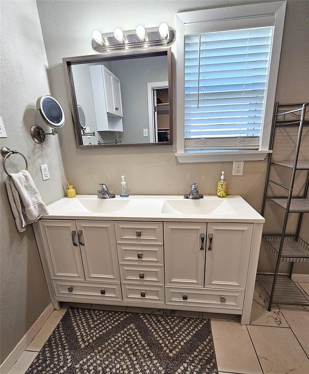 1205 West Trinity Street Groesbeck, TX 76642 - Photo 13 of 28 a bathroom with a sink and a mirror