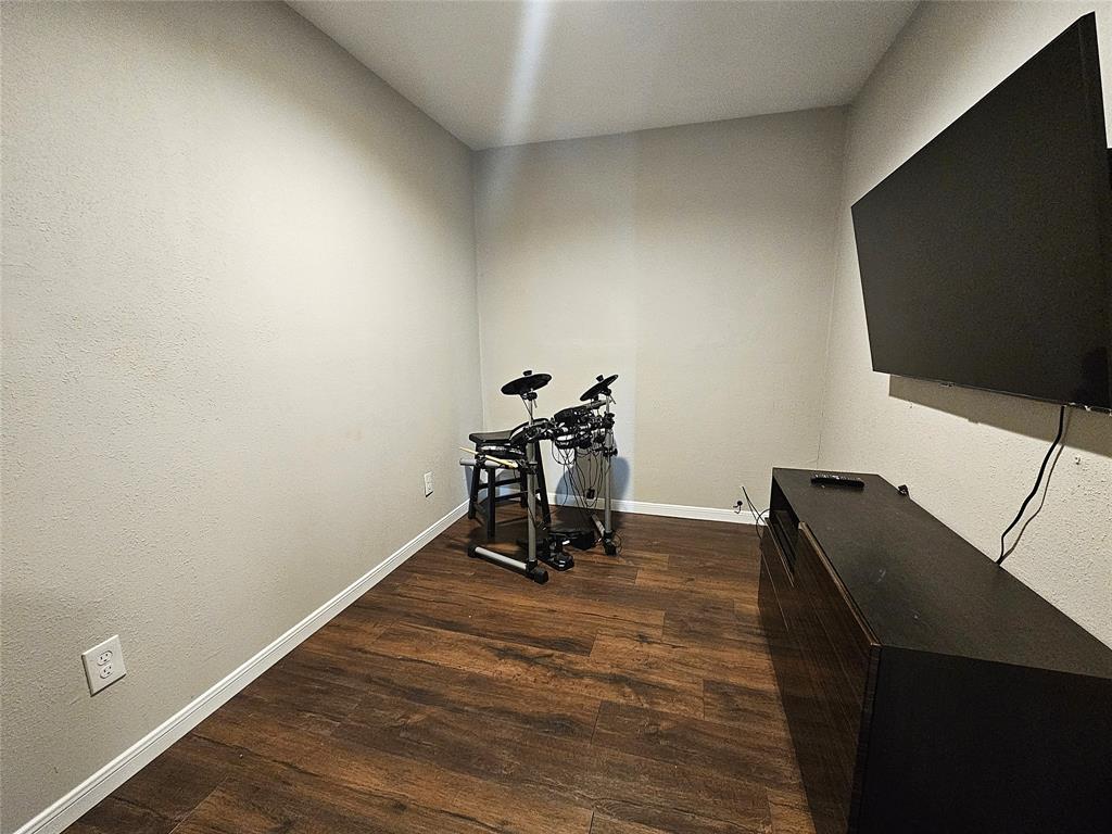 1205 West Trinity Street Groesbeck, TX 76642 - Photo 19 of 28 a room with furniture and wooden floor