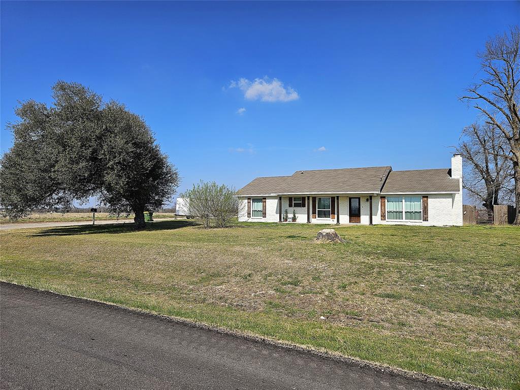 1205 West Trinity Street Groesbeck, TX 76642 - Photo 27 of 28 a front view of a house with a garden